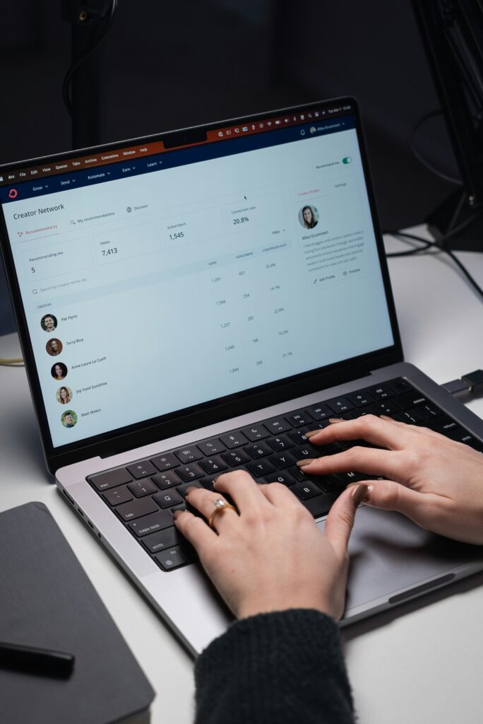 Person typing on a laptop with a chat dashboard